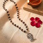Karungali Murugan mala by Saadhak with sacred beads and Lord Murugan pendant for protection, strength, and spiritual wear.