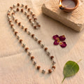 Rudraksha mala by Saadhak with silver-plated "Om Namah Shivaya" engraved beads for devotion, peace, and spiritual wear.