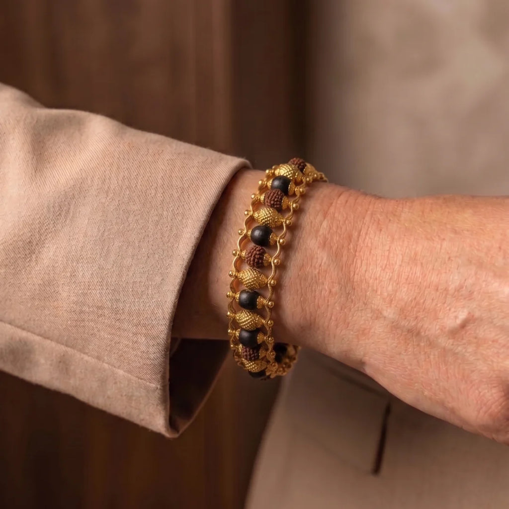 Handcrafted Karungali and Rudraksha Gold Plated bracelet by Saadhak featuring authentic ebony wood and Rudraksha beads.