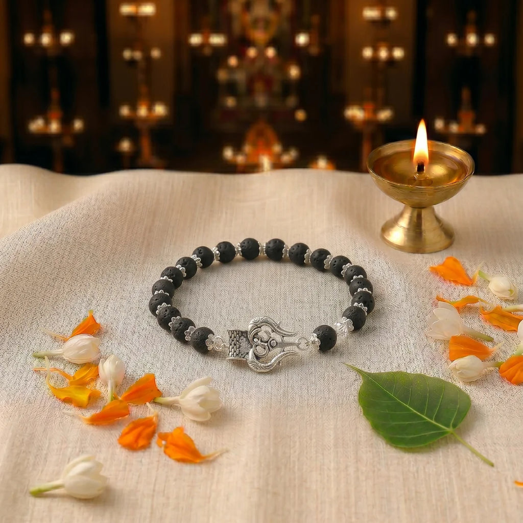 Handcrafted Lava and Trishul Silver Cap bracelet by Saadhak featuring natural lava stone beads and a Trishul charm.